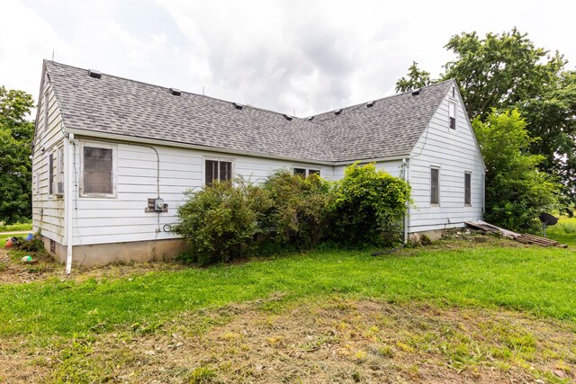 8620 Scio Church Rd, Ann Arbor, MI 48103 - view of side of home with a shingled roof and a yard