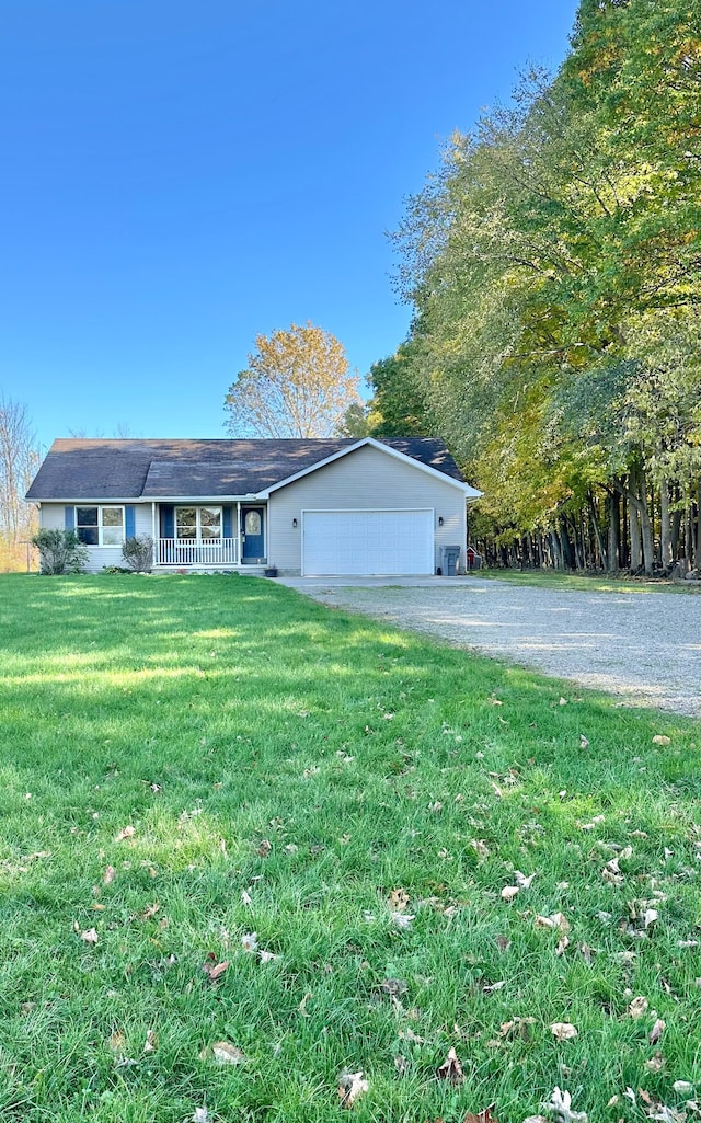 view of front facade with a front yard, a porch, and a garage