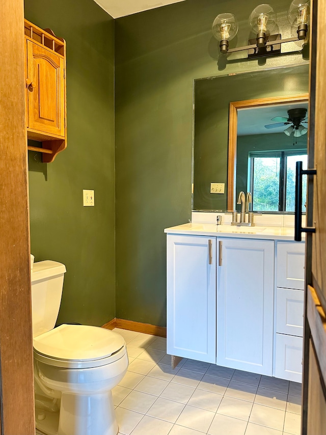 bathroom featuring tile patterned flooring, vanity, toilet, and ceiling fan