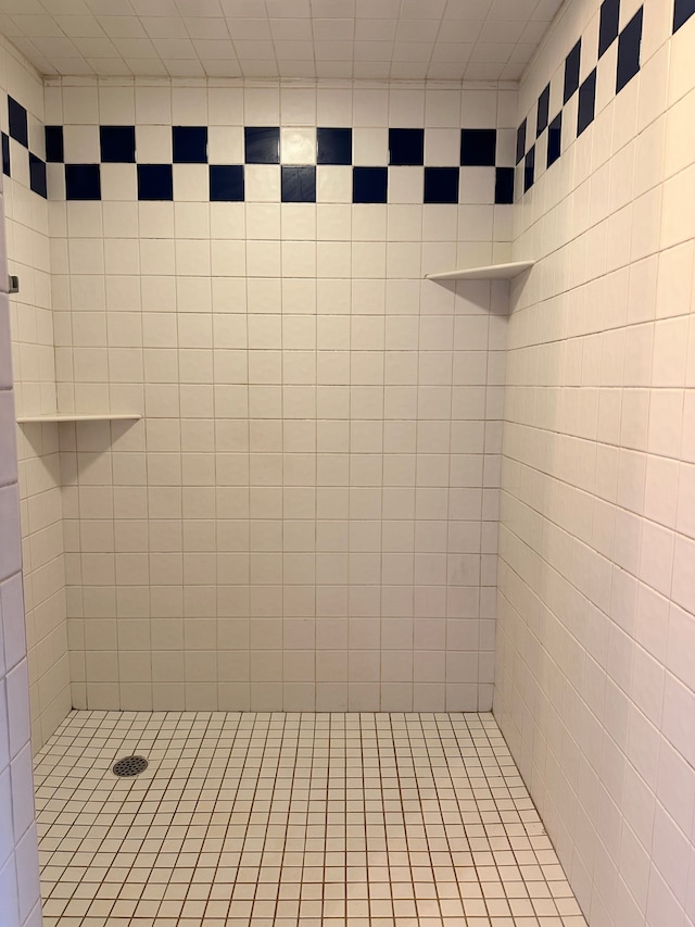 bathroom with a tile shower