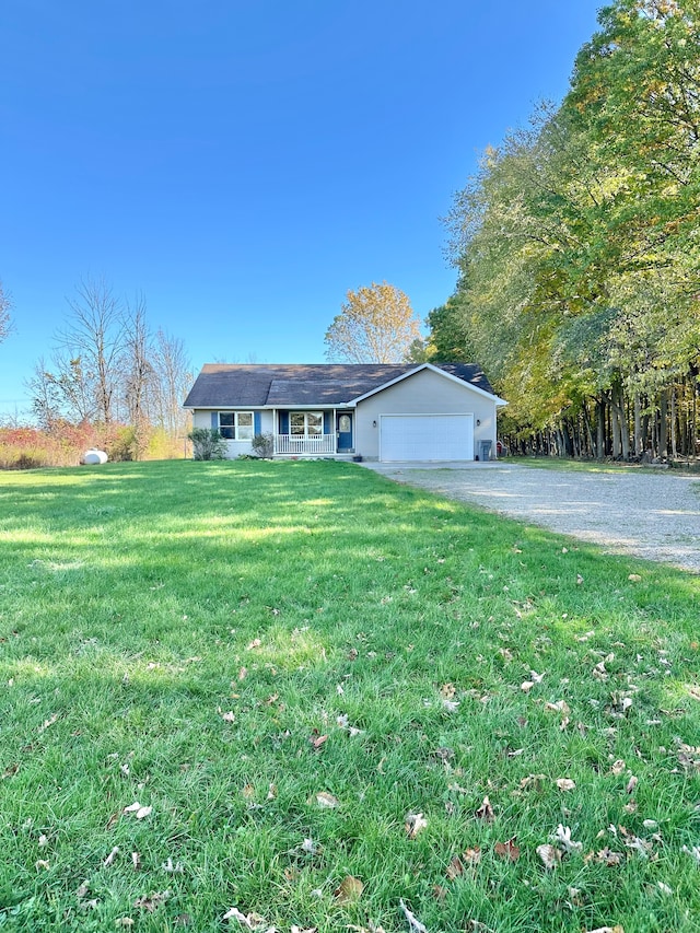 view of front facade with a front lawn, covered porch, and a garage