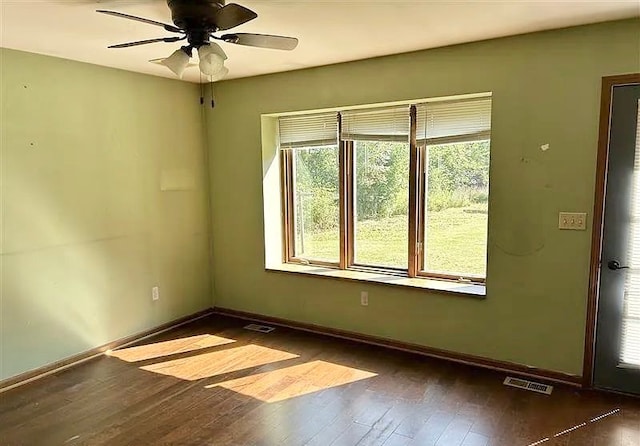 unfurnished room with ceiling fan and dark hardwood / wood-style floors