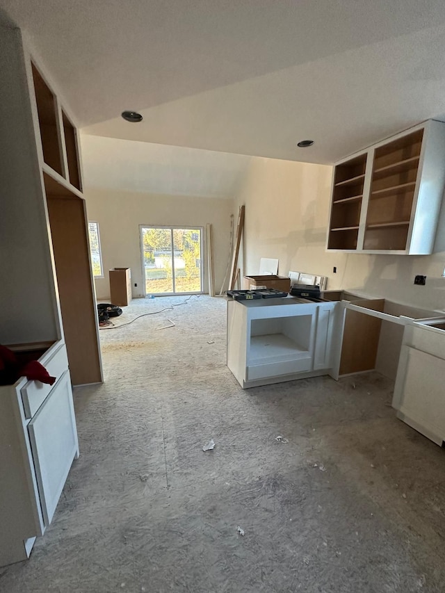 kitchen with a textured ceiling and lofted ceiling