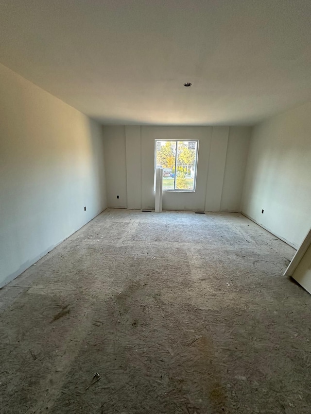 unfurnished room featuring light carpet