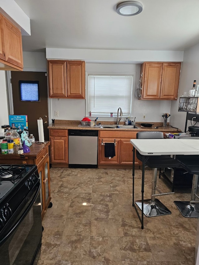 kitchen featuring stainless steel dishwasher, black range, and sink