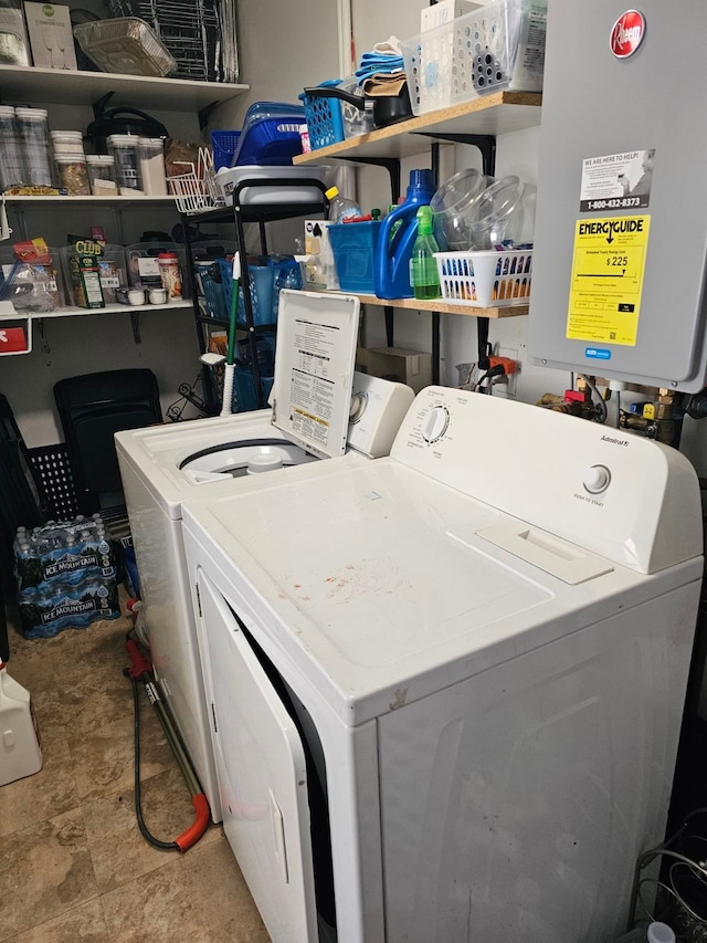 laundry room with tankless water heater and washing machine and dryer