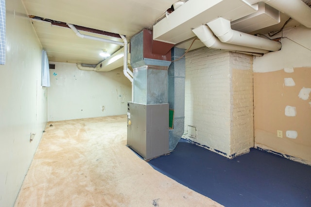 basement featuring carpet floors and heating unit