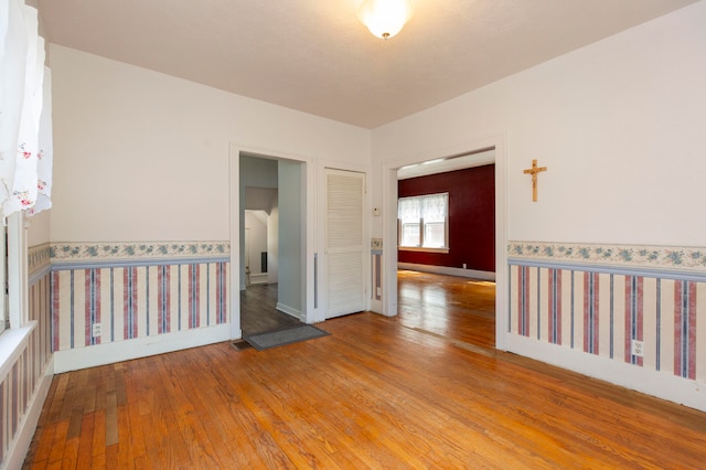 empty room with light hardwood / wood-style flooring