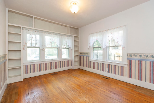 unfurnished room featuring hardwood / wood-style floors