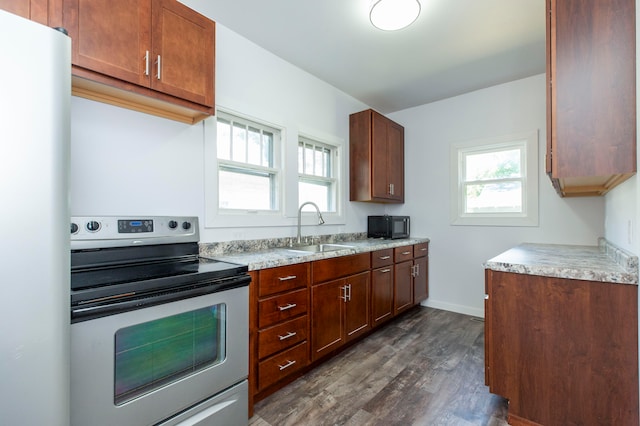 kitchen with white refrigerator, dark hardwood / wood-style flooring, electric stove, and sink