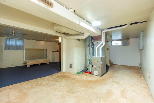 basement featuring carpet and heating unit