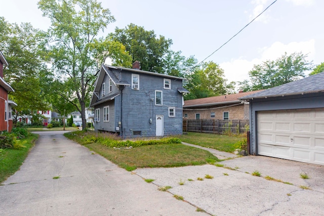 view of side of property with a yard and a garage