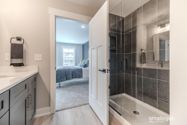 bathroom with vanity and a shower with door