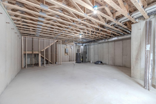 basement with electric panel, heating unit, and water heater