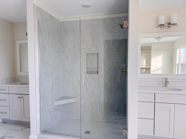 bathroom with vanity and a shower with door