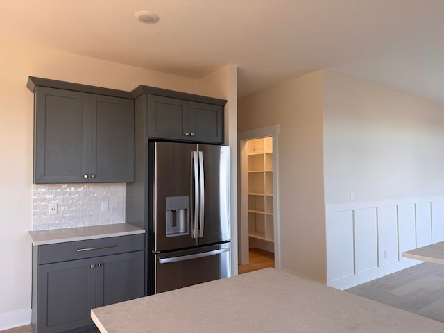 kitchen featuring stainless steel fridge with ice dispenser, tasteful backsplash, and gray cabinets