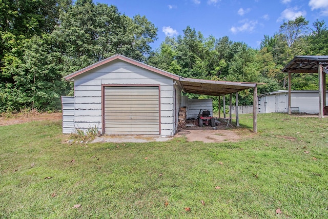 garage with a carport and a lawn