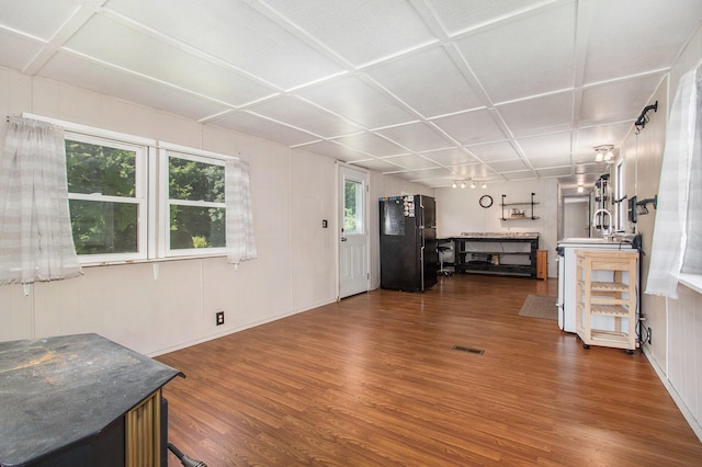 living room with a wealth of natural light, hardwood / wood-style floors, and sink