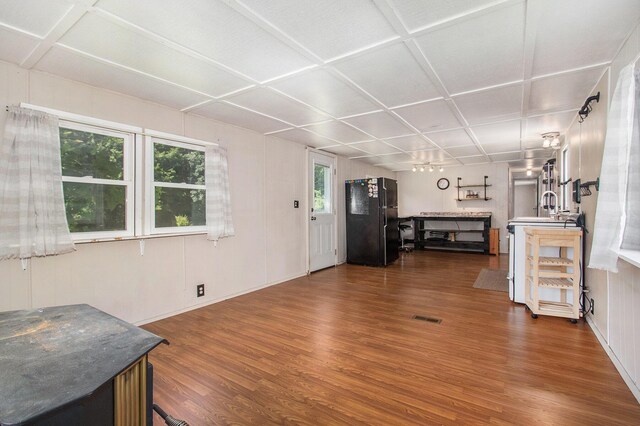 6662 Lorne Dr, Pentwater, MI 49449 - unfurnished living room featuring dark wood-type flooring, coffered ceiling, and baseboards