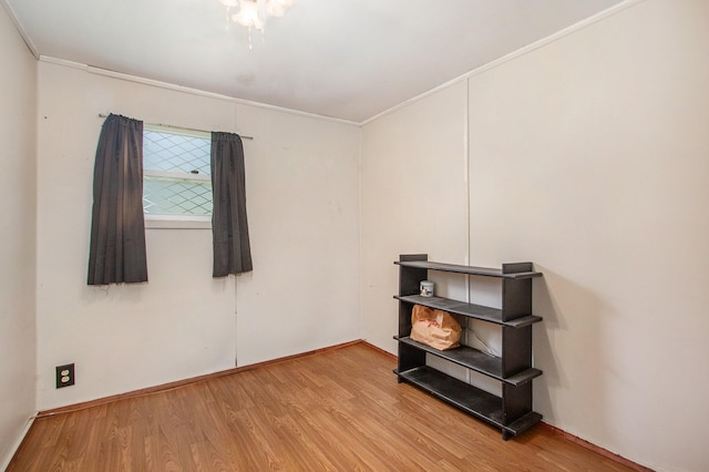 misc room with hardwood / wood-style flooring and crown molding