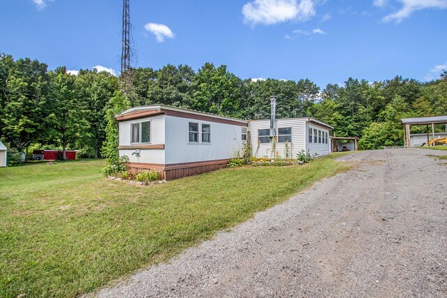 6662 Lorne Dr, Pentwater, MI 49449 - manufactured / mobile home with driveway and a front lawn