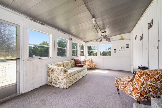 sunroom / solarium with plenty of natural light, ceiling fan, rail lighting, and vaulted ceiling