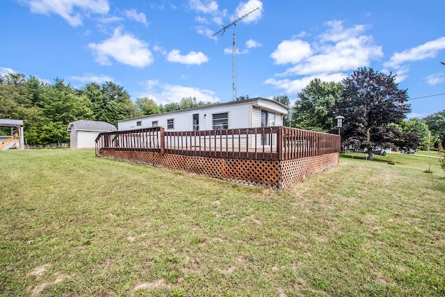 rear view of property with a yard and a deck