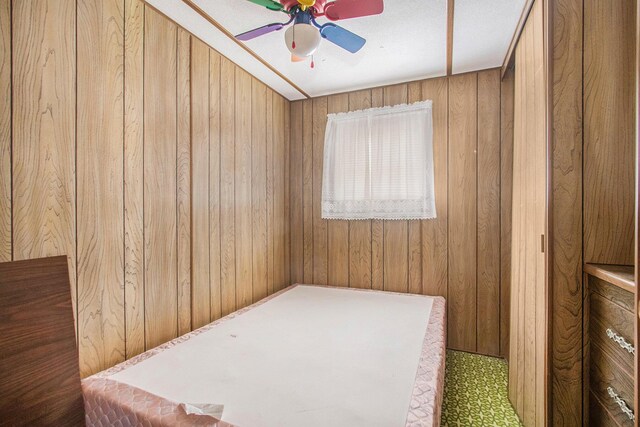 6662 Lorne Dr, Pentwater, MI 49449 - bedroom featuring wooden walls and a ceiling fan