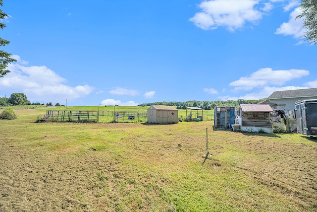 view of yard with a rural view and a shed