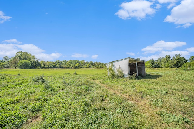 view of yard featuring an outbuilding and a rural view