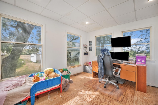 office space featuring a paneled ceiling and light wood-type flooring