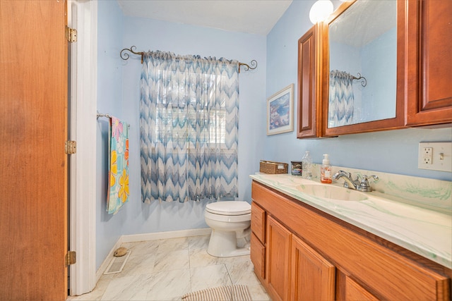 bathroom featuring vanity and toilet