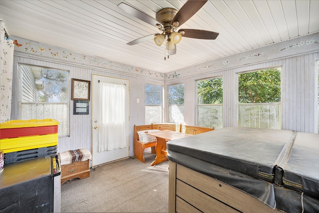 sunroom / solarium featuring ceiling fan and wooden ceiling