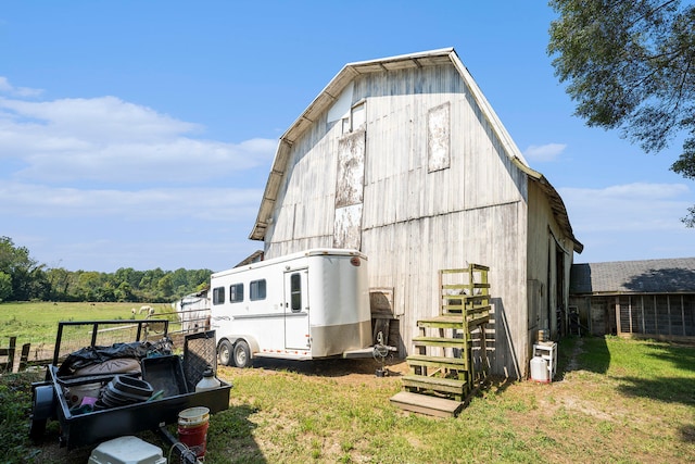 exterior space featuring a lawn and an outbuilding