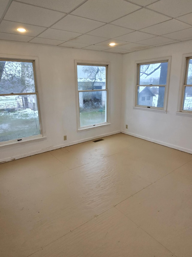 spare room with a paneled ceiling