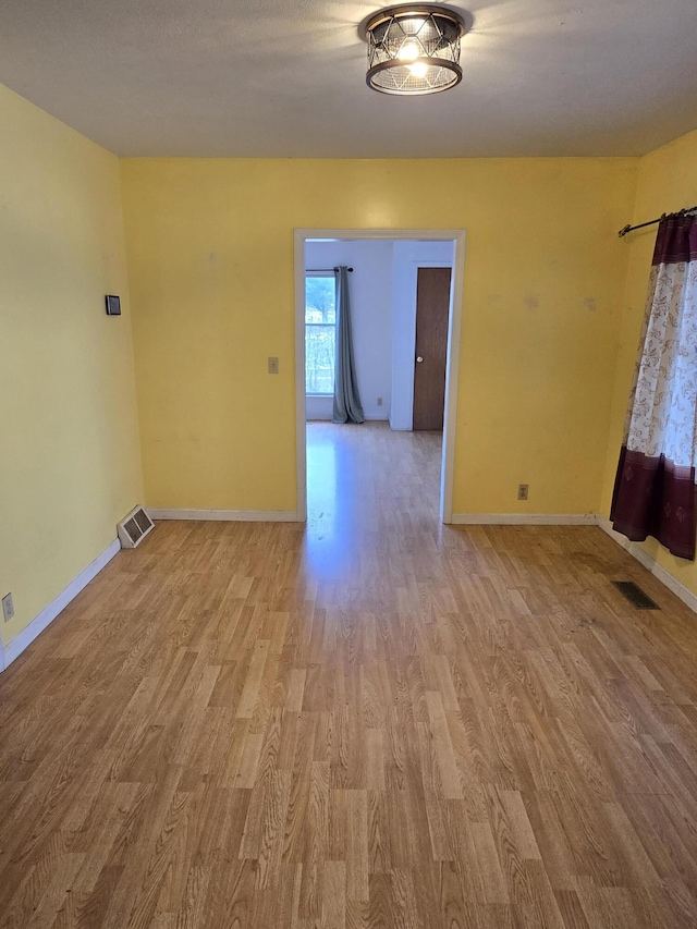 empty room with light hardwood / wood-style floors