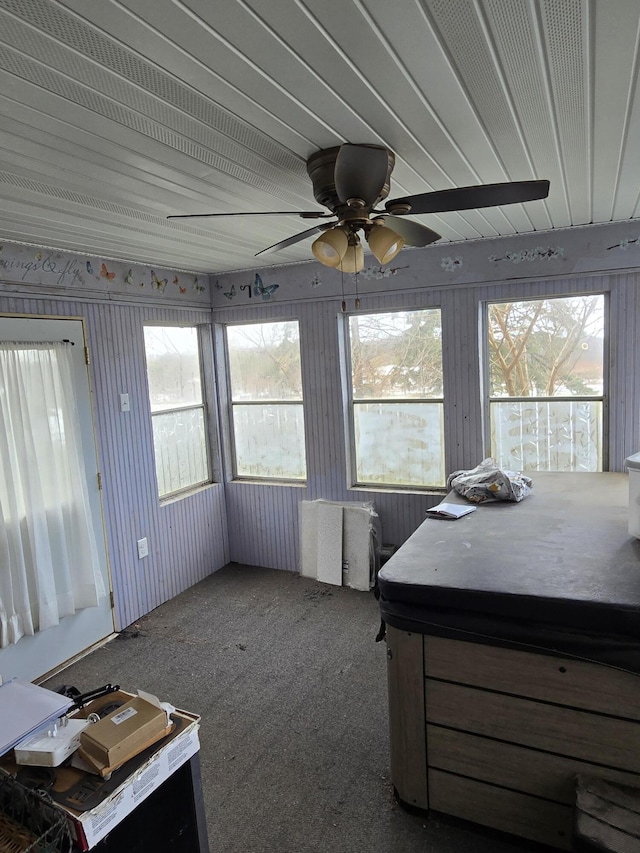 unfurnished sunroom with ceiling fan