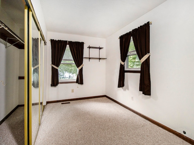 unfurnished bedroom with a closet and carpet floors