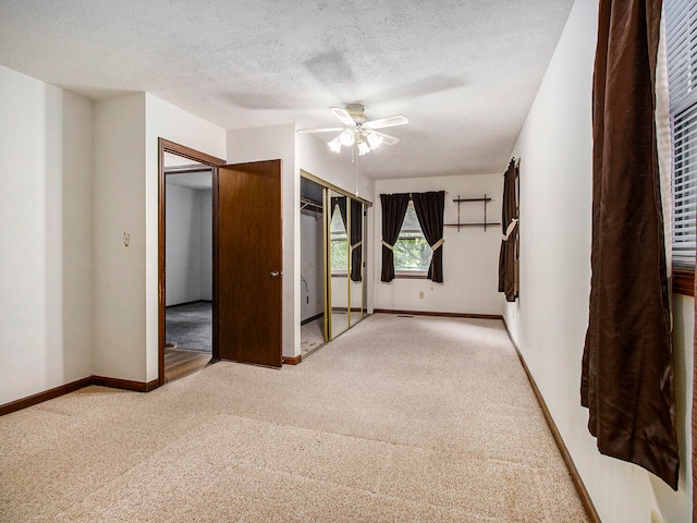 unfurnished room with carpet, a textured ceiling, and ceiling fan