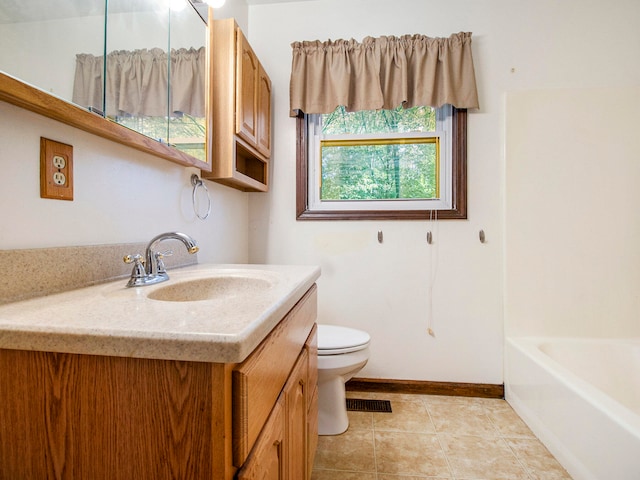 bathroom with toilet, vanity, tile patterned floors, and a bathing tub