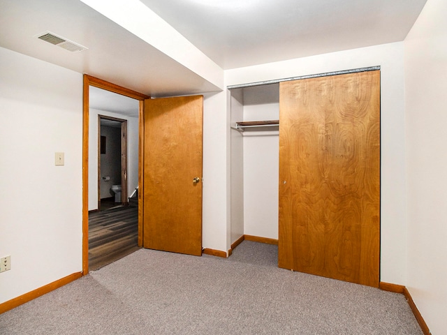 unfurnished bedroom with a closet and carpet