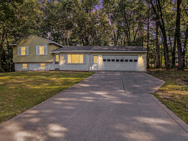 split level home with a front yard and a garage