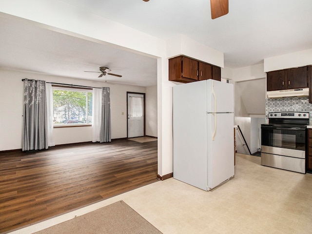 kitchen featuring light wood-type flooring, backsplash, dark brown cabinets, white fridge, and stainless steel range with electric cooktop