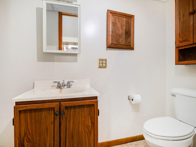 bathroom with tile patterned floors, vanity, and toilet