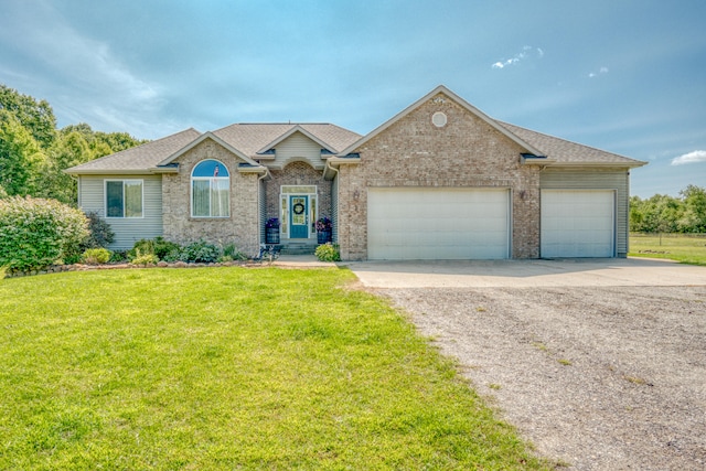 view of front of property with a garage and a front lawn