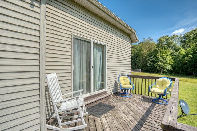 wooden deck with a lawn