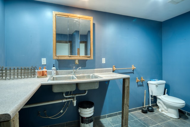 bathroom with tile patterned flooring, toilet, and sink