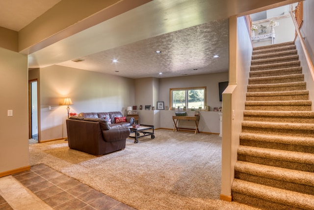 carpeted living room featuring a textured ceiling