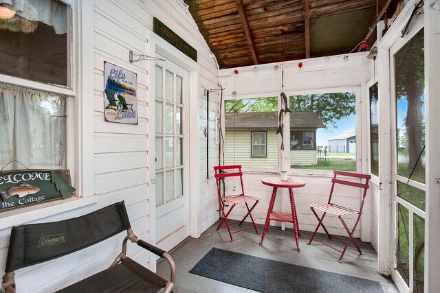 sunroom with wooden ceiling and vaulted ceiling