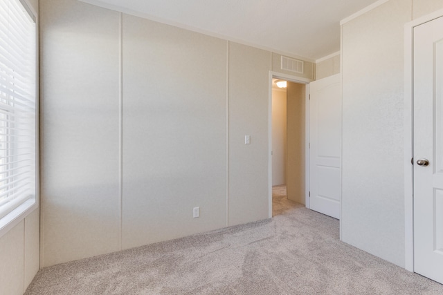 unfurnished bedroom with light colored carpet